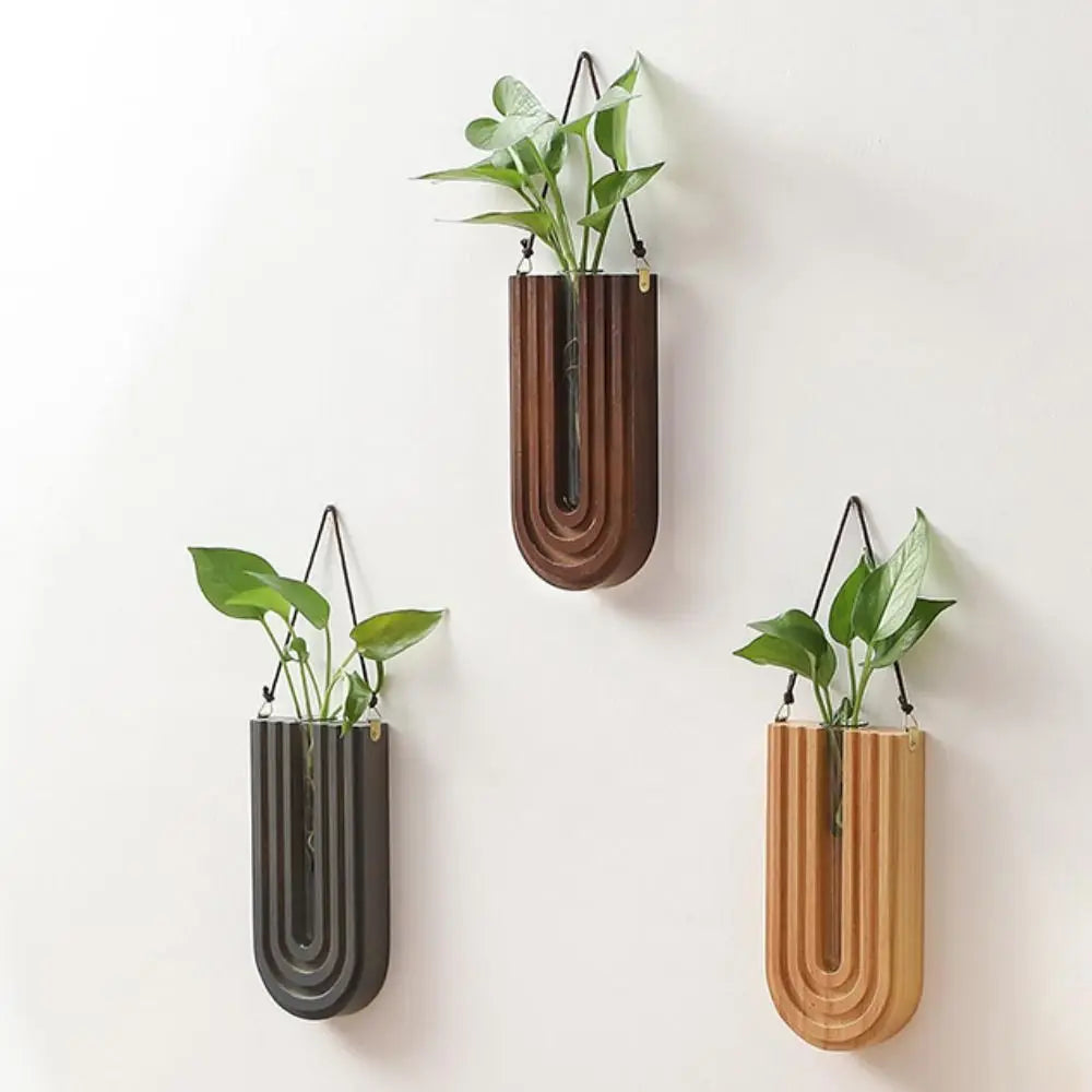 Handcrafted wooden wall-mounted hydroponic plant vase with green leaves