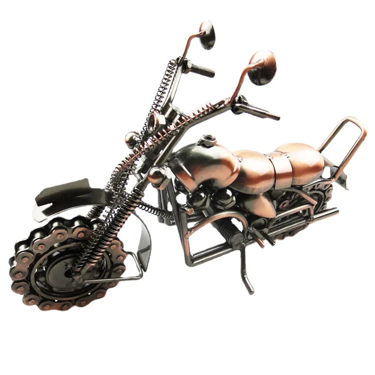 A vintage iron motorcycle figurine with detailed mechanical parts and a metallic finish.