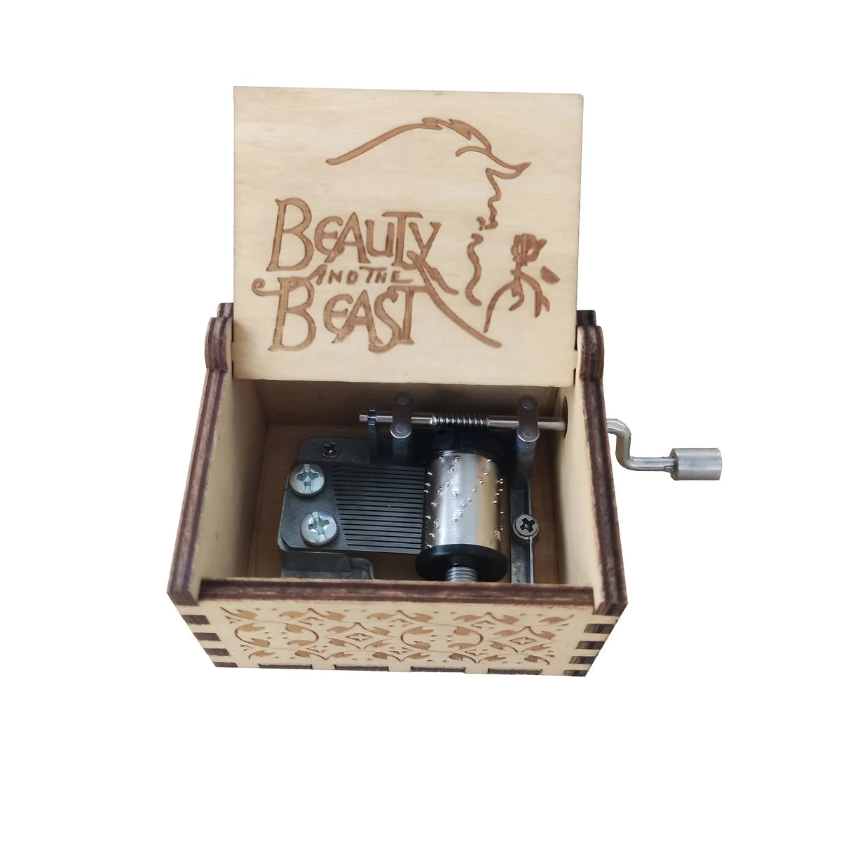 Antique carved wooden music box with a lid featuring the text Beauty and the Beast and an internal mechanism.