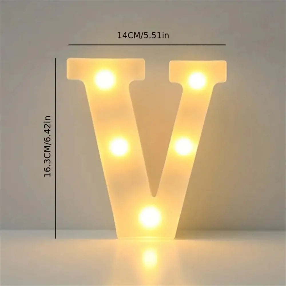A glowing letter V made of LED lights on a white surface.
