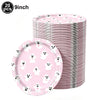 A stack of pink ghost-themed Halloween party plates and bowls.