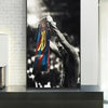 A black and white art print of Lionel Messi celebrating with a football, featuring his jersey.