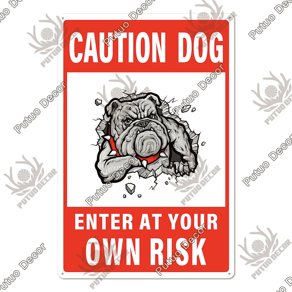 A vintage warning metal sign with the text CAUTION DOG and ENTER AT YOUR OWN RISK featuring a bulldog illustration.