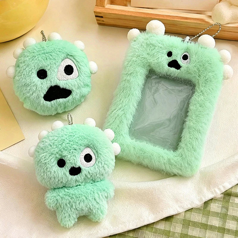 A light green fluffy plush keychain with a clear plastic holder for photos is displayed on a white cloth.