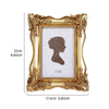 Gold-framed rectangular photo frame with a distressed finish and a silhouette of a profile face inside