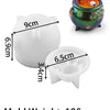 A white silicone mold set with various sizes and a decorative green pot containing Halloween-themed items.