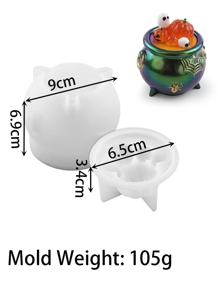 A white silicone mold set with various sizes and a decorative green pot containing Halloween-themed items.