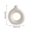 A white ceramic-style vase with a smooth, rounded body and a large circular opening.