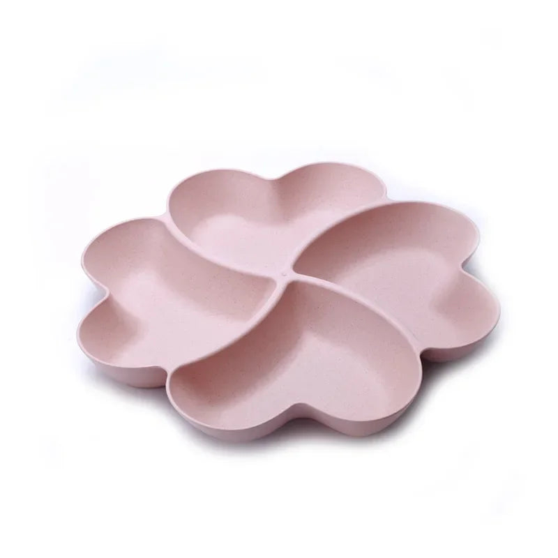 A pink heart-shaped four-compartment silicone snack tray with rounded edges.