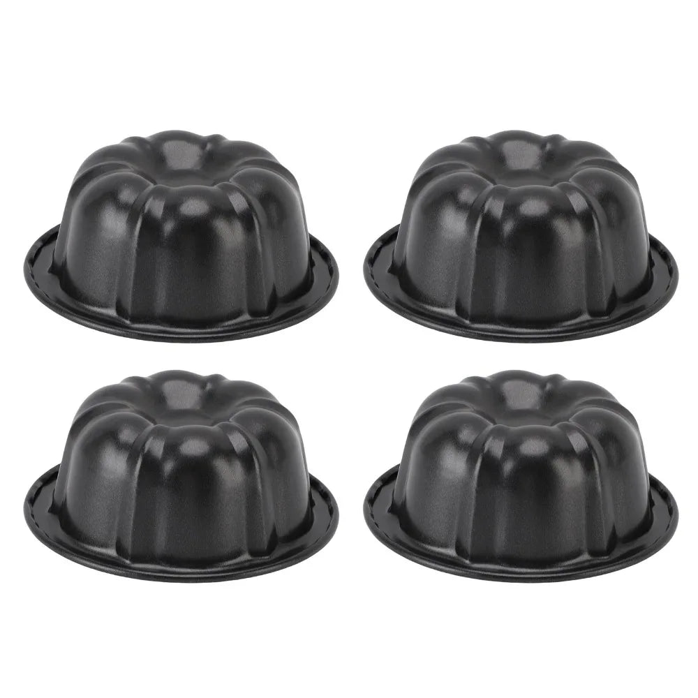 A set of four black nonstick mini fluted cake pans arranged in a 2x2 grid.