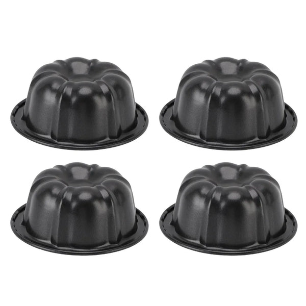 A set of four black nonstick mini fluted cake pans arranged in a 2x2 grid.