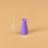 A small, purple miniature resin vase with a narrow neck is shown against a plain background.