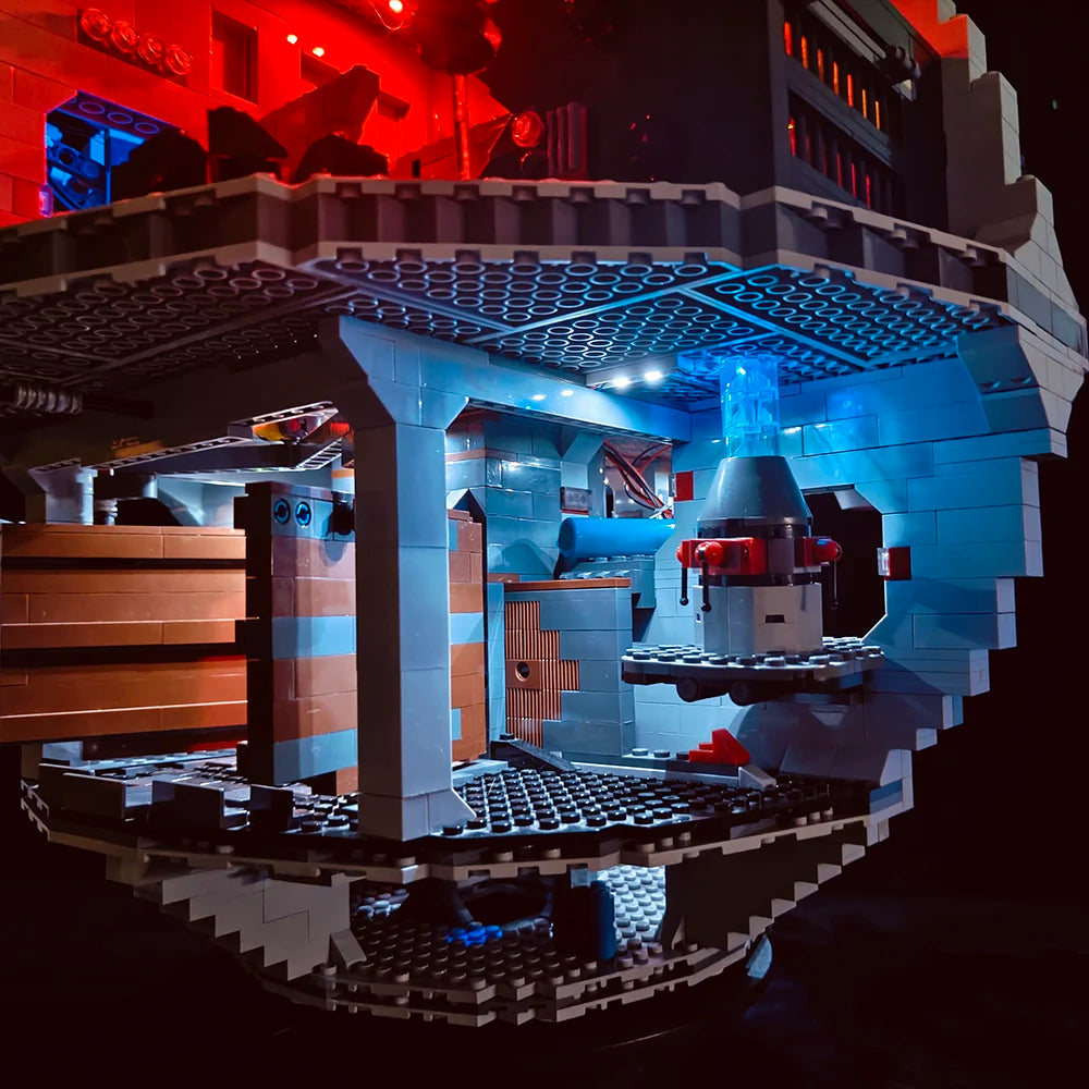 A LEGO model of a Death Star with blue LED lighting illuminating the interior and exterior.