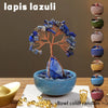 A blue crystal money tree with a blue base and gold coins in a bowl.