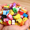 A hand holds a colorful set of cartoon animal pencils with eraser tops for a back-to-school kit.