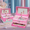 A pink jewelry box for unicorn music featuring a rotating dancer figurine and various sparkly accessories.