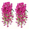 A bunch of artificial hanging morning glory flowers in vibrant pink and magenta with green eucalyptus leaves.