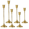 Set of three matte gold taper candle holders with flared bases