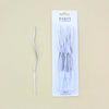 A package of 12 long thin silver spiral candles for parties