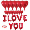 A set of red foil balloons shaped like the words I LOVE YOU and hearts