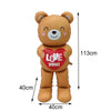 A plush teddy bear toy with a red heart design and text on its chest