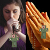 Close-up of a hand holding a handmade prayer quilt with a silver cross pocket shrine.