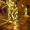 Wooden trellis decorated with warm white string lights and green foliage for outdoor or indoor home decor