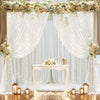 Elegant white wedding tulle backdrop decorated with floral garlands and string lights