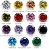 A collection of loose round cut cubic zirconia stones in various colors including white, yellow, champagne, olive green, oran
