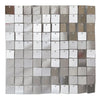 A grid of square iridescent sequins in silver and gold shades used as a shimmering wall backdrop.
