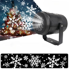 Outdoor LED projector light featuring white snowflakes and festive patterns on a dark background