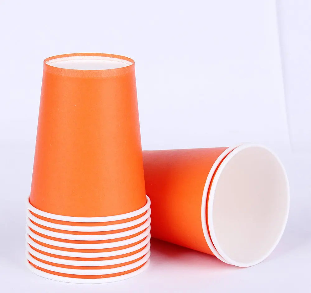 A stack of orange disposable cups with white striped rims and a single orange cup.