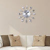 A silver modern cutlery 3D wall clock with fork shapes radiating from the center.