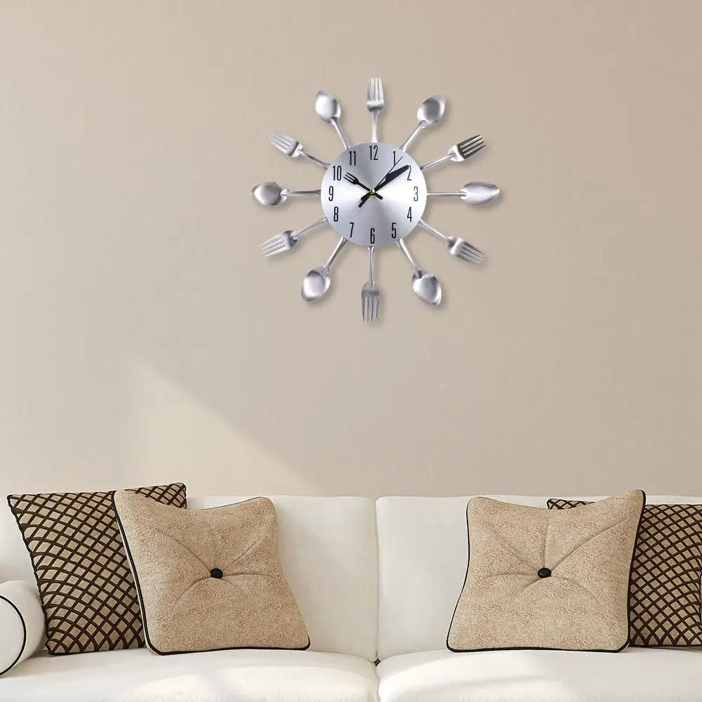 A silver modern cutlery 3D wall clock with fork shapes radiating from the center.