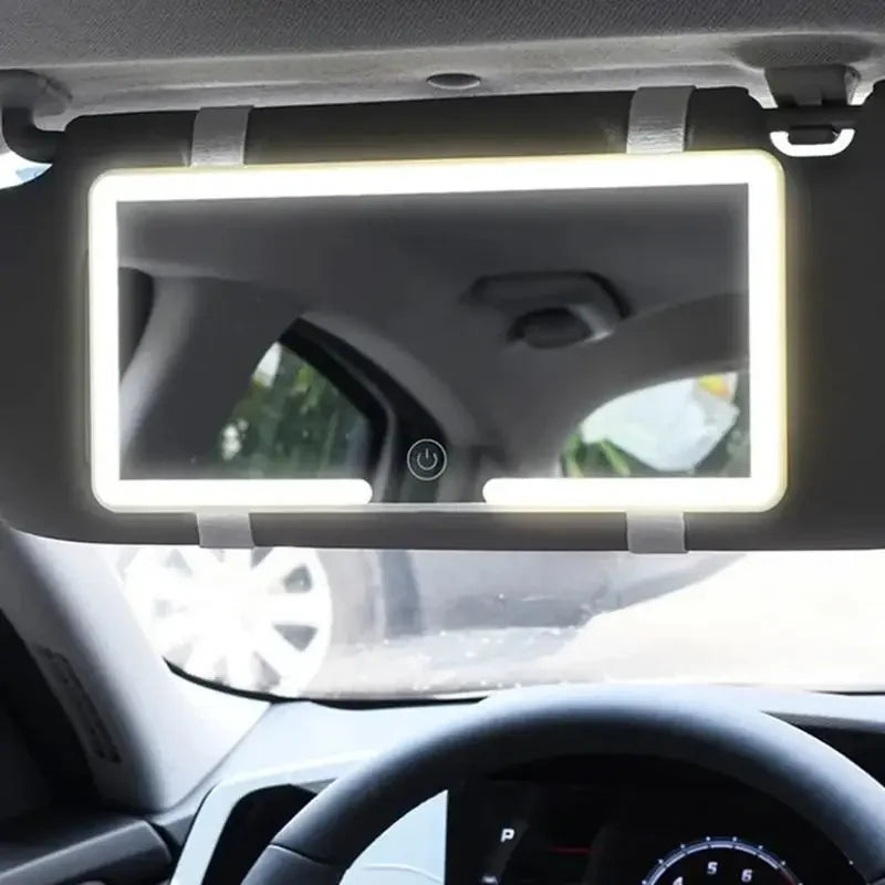 An LED vanity mirror mounted on a car's interior, featuring adjustable straps.