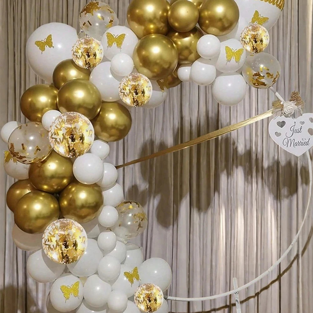A cluster of pearl white and gold confetti balloons tied together, suggesting a wedding or celebration theme.