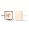 A light pink gift box with a bow and a bear pendant necklace inside.