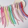 A collection of colorful nylon ropes in various shades including pink, yellow, green, and purple, arranged on a white plate.