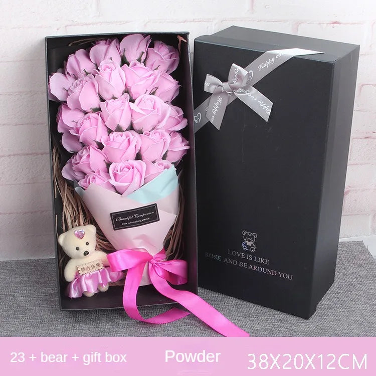A gift box containing a bouquet of pink roses and a teddy bear for a romantic gesture