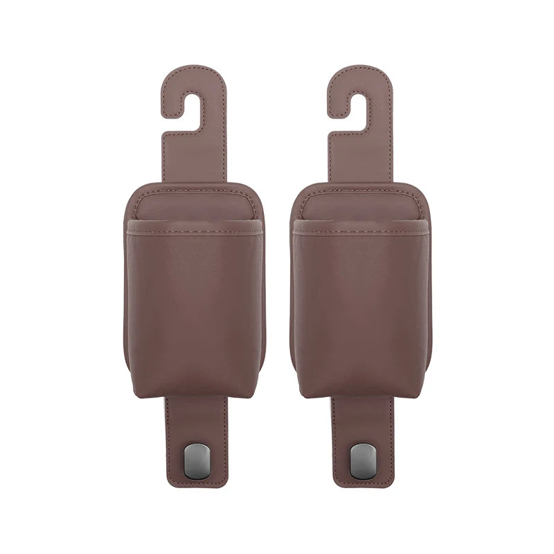 A pair of brown leather car seat back organizers with headrest hangers and mounting tabs.