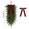 Artificial Christmas teardrop swag made of green pine needles with a red ribbon bow