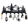 Black metal key holder with mountain forest silhouette and multiple hooks for keys and small items