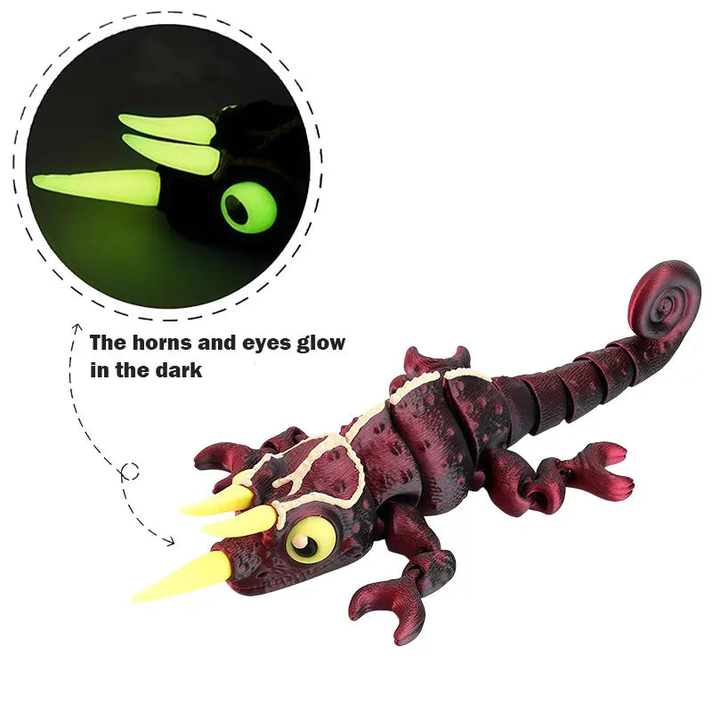 A dark red chameleon fidget toy with glowing yellow horns and eyes, showing its glow in the dark feature.