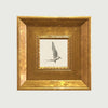 An elegant gold photo frame set with a framed bird silhouette inside.