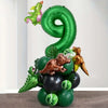 A green balloon set shaped like the number 9 and various dinosaur-themed balloons for a party decoration.
