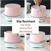 A pink layer cake is shown being decorated with a silver knife on a white cake board, emphasizing slip resistance for easy de