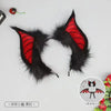 A pair of black bat-eared headwear with red accents, suitable for cosplay or performance.