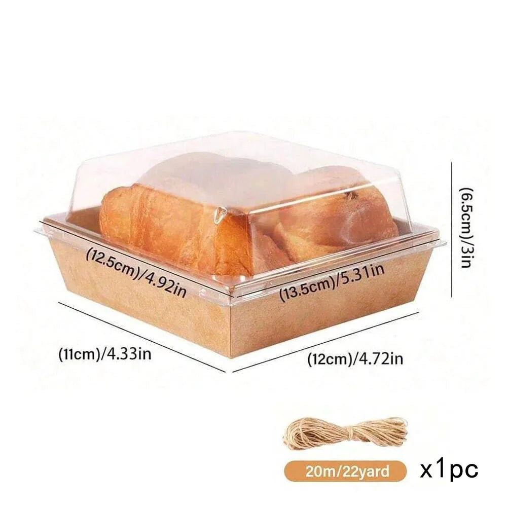 A clear plastic box containing a loaf of bread or pastry, packaged in a brown kraft cardboard tray.