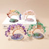 A display of natural amethyst crystal trees on agate bases, used as feng shui money trees for home decor.