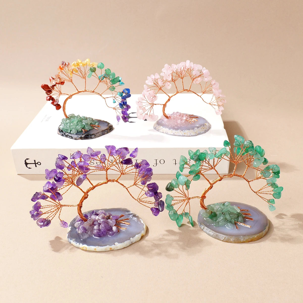 A display of natural amethyst crystal trees on agate bases, used as feng shui money trees for home decor.